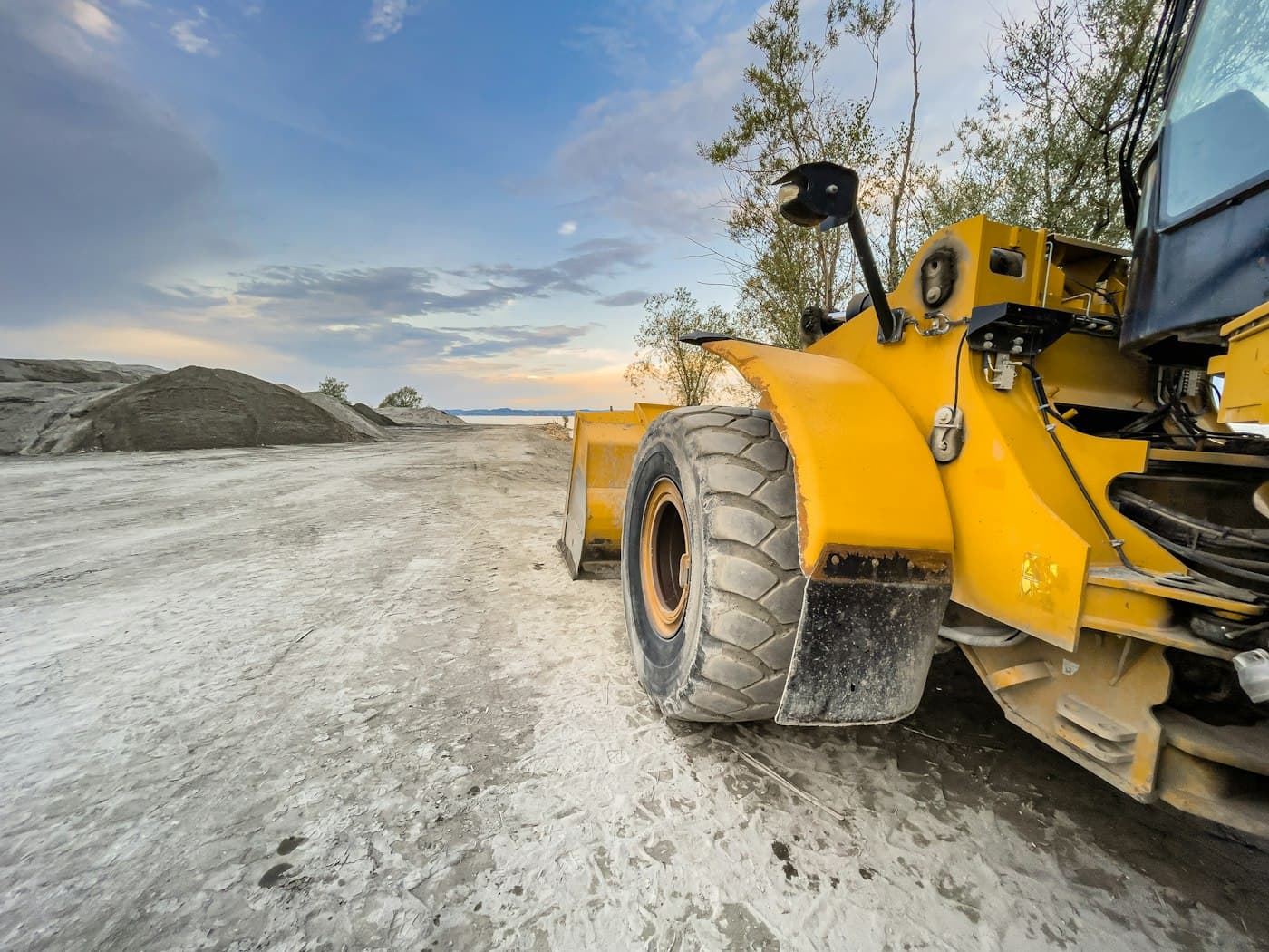A dozer parked on a graded dirt road.